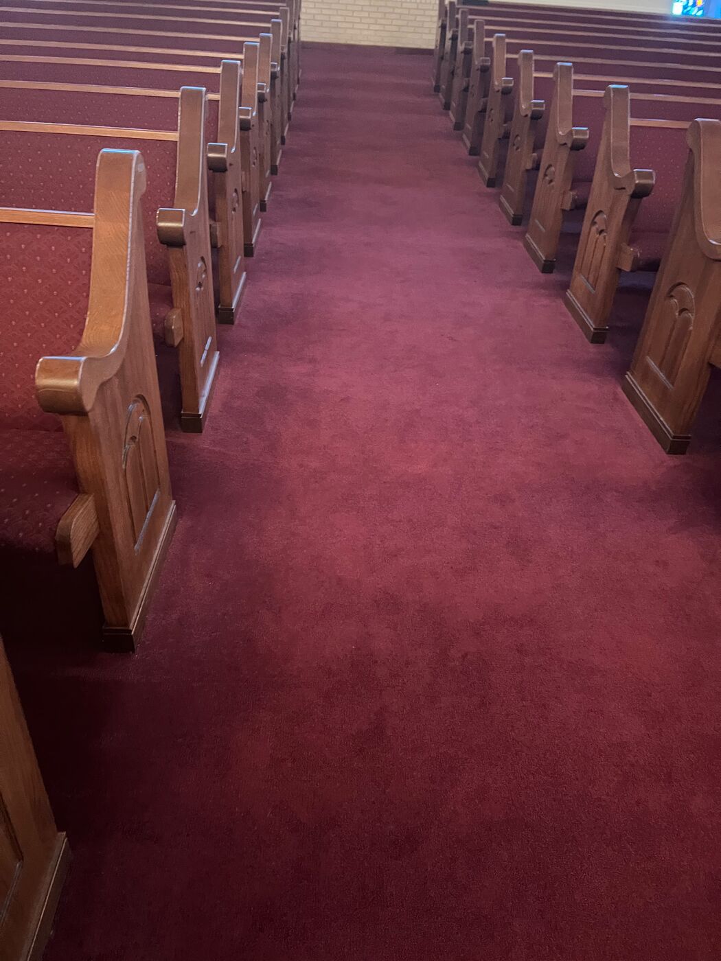 Church aisle carpet with wooden pews